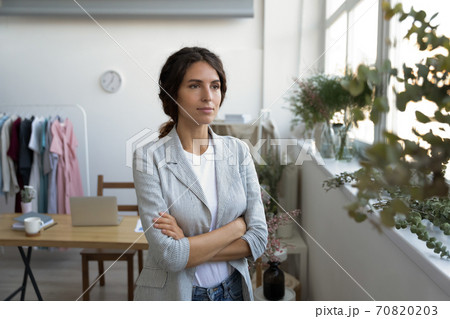 Dreamy female designer look in distance thinking visualizing Dreamy female designer look in distance thinking visualizing 70820203