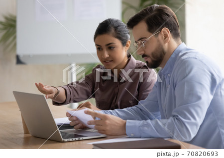 Diverse businesspeople work on laptop brainstorming in office 70820693
