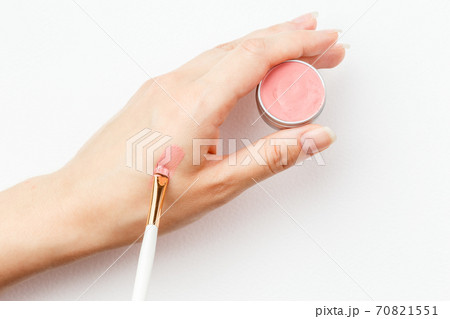 Making a swatch on a female hand of pink lipstick Making a swatch on a female hand of pink lipstick 70821551