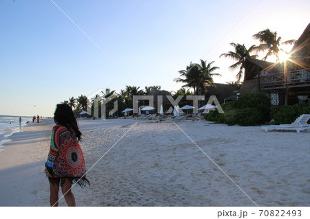 girl walking on white sandy beach of caribbean at sunset in Tulum, Mexico girl walking on white sandy beach of caribbean at sunset in Tulum, Mexico 70822493