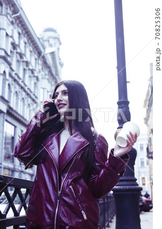 young pretty girl outside in city street with coffee happy smiling, lifestyle fashion peopple concept 70825306