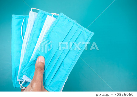 man hand holding surgical face mask, close up  70826066