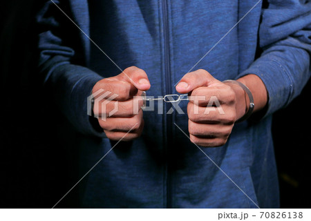man's hand with handcuff on black background. man's hand with handcuff on black background. 70826138
