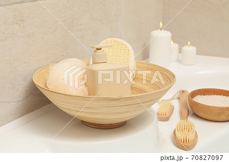 Bath with personal hygiene accessories in light beige bathroom 70827097