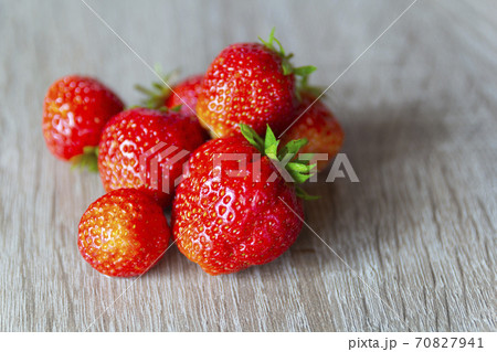 Pile of strawberries on a grey stone background. Selective focus Pile of strawberries on a grey stone background. Selective focus 70827941