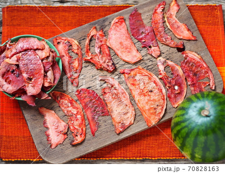 Dried slices of watermelon on the kitchen board. Homemade preparations of dried watermelon for future use.Healthy natural food. 70828163