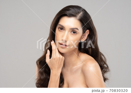 Beautiful Glamour indian woman touch chin smile with clean and fresh skin Happiness and cheerful with positive emotional,isolated on grey background,Beauty Cosmetics and spa Facial treatment Concept 70830320