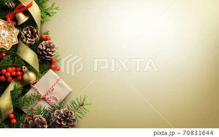 Christmas border composition made of fir branches, cones and gift box on light golden background 70831644