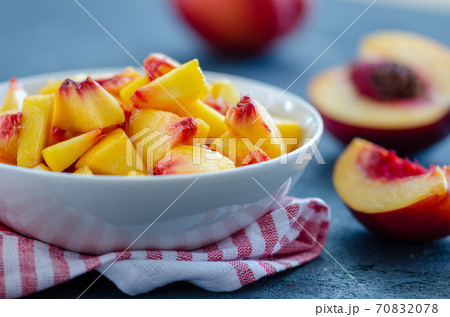 Chopped peaches on a table, closeup. Chopped peaches on a table, closeup. 70832078