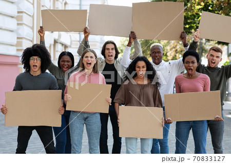 Furious mutiracial group of demonstrators protesting on the street 70833127