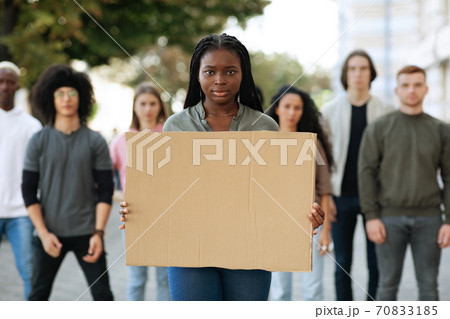 Black woman with empty placard leading group of protestors Black woman with empty placard leading group of protestors 70833185