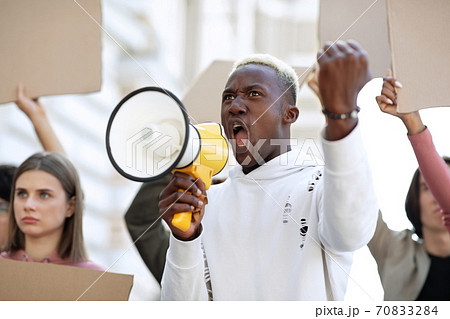 Closeup of black motivated guy leading group of strikers 70833284