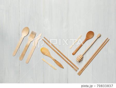 Wooden Cutlery and kitchen utensils on light boards. Top view, horizontally with space 70833837