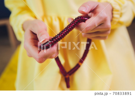 Muslim woman in hijab praying on mat indoors. Muslim woman in hijab praying on mat indoors. 70833891