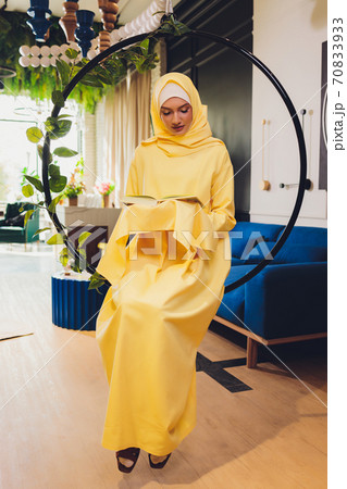 A young Muslim woman reads the Quran in a mosque in Ramadan month. A young Muslim woman reads the Quran in a mosque in Ramadan month. 70833933