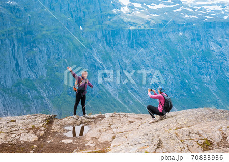 Two sporty women near Norway fjord making photo Two sporty women near Norway fjord making photo 70833936