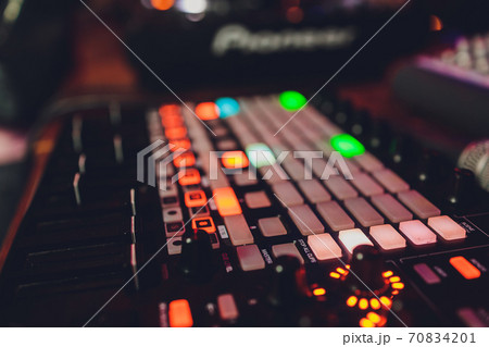 The DJ's hand on the mixer. Dj on the turntables. hand on a mixer close-up. Girl Man DJ at the mixer remote. The DJ's hand on the mixer. Dj on the turntables. hand on a mixer close-up. Girl Man DJ at the mixer remote. 70834201
