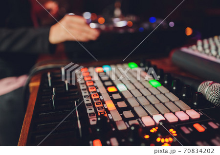 The DJ's hand on the mixer. Dj on the turntables. hand on a mixer close-up. Girl Man DJ at the mixer remote. The DJ's hand on the mixer. Dj on the turntables. hand on a mixer close-up. Girl Man DJ at the mixer remote. 70834202