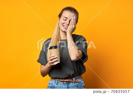 Photo of cheerful positive curly pretty sweet girlfriend holding mug of coffee smiling toothily isolated over vivid color background. Photo of cheerful positive curly pretty sweet girlfriend holding mug of coffee smiling toothily isolated over vivid color background. 70835057
