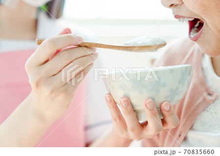 フェイスガードをして食事介助のアップ フェイスガードをして食事介助のアップ 70835660