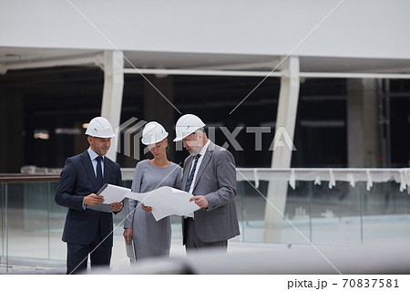 Group of Business People Touring Construction Site Group of Business People Touring Construction Site 70837581