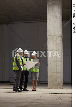 Inspection Committee Discussing Plans at Construction Site Inspection Committee Discussing Plans at Construction Site 70837611