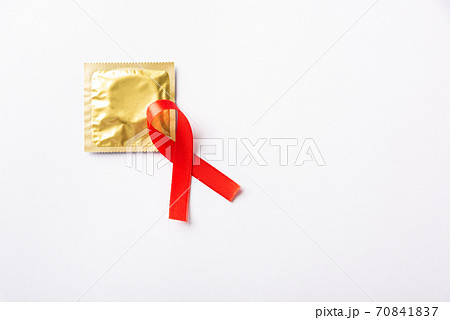 Red bow ribbon symbol HIV, AIDS cancer awareness and condom 70841837