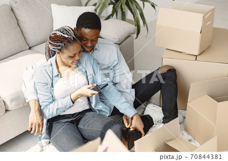 Couple with boxes moving into new home smiling 70844381