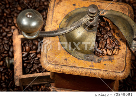 Closeup of a Manual Coffee Grinder with Roasted Coffee Beans - Italy 70849091