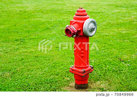 red isolated fire hydrant sits in a freshly cut grass field 70849966