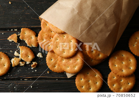 Paper bag with cracker biscuits on wooden background 70850652