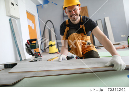 Man builder holds laminate board in his hands 70851262