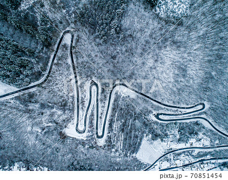 Seasons Concept winter snowy Aerial view Winding road serpentine mountain pass village Brodenbach Germany Seasons Concept winter snowy Aerial view Winding road serpentine mountain pass village Brodenbach Germany 70851454