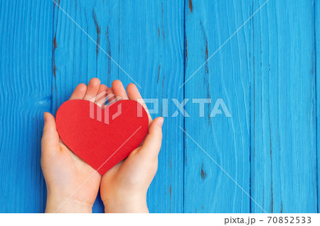 Red heart in child's hands 70852533