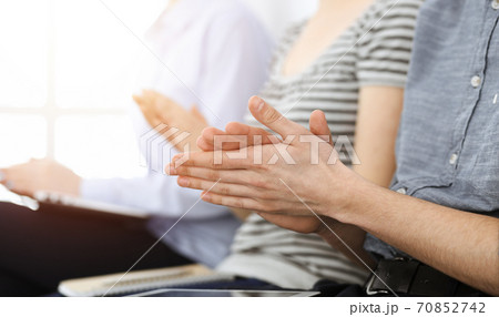 Business people clapping at meeting or conference, close-up of hands. Group of unknown businessmen and women in sunny office 70852742