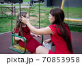 Child and mom in medical mask on a walk. Family wearing face mask 70853958