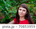 portrait of a young woman in red clothes	 70853959