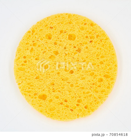 A round yellow cosmetic sponge pad for face make-up cleaning on white background A round yellow cosmetic sponge pad for face make-up cleaning on white background 70854618
