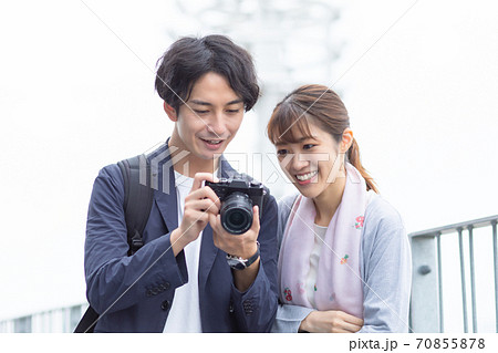 観光旅行で撮影した写真を確認するカップル　写真素材 70855878