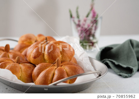Pumpkin buns bread on grey background. Halloween Food Concept. Autumn concept. Pumpkin buns bread on grey background. Halloween Food Concept. Autumn concept. 70855962