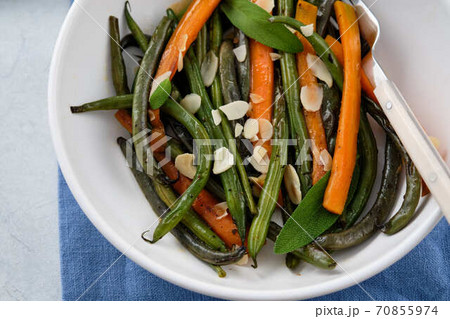Green beans with carrots cooked with olive oil and sage. Healthy food. Green beans with carrots cooked with olive oil and sage. Healthy food. 70855974