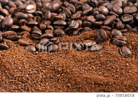 Coffee Beans and Grounds background.Roasted coffee beans and grounds close up from above selective focused. Coffee Beans and Grounds background.Roasted coffee beans and grounds close up from above selective focused. 70858058