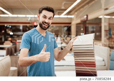 A man with a beard smiles and shows super gesture. A man with a beard smiles and shows super gesture. 70858284