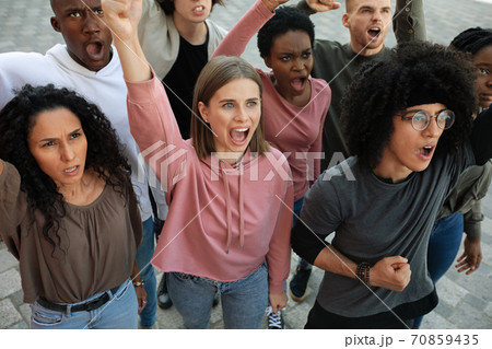 Students yelling slogans and showing fists during demonstration, top view Students yelling slogans and showing fists during demonstration, top view 70859435