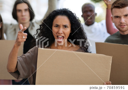 Demonstrators making riot on the street, holding blank placards Demonstrators making riot on the street, holding blank placards 70859591