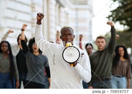 Black man with megaphone leading group of protestors Black man with megaphone leading group of protestors 70859757