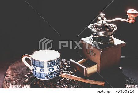Coffee grinder,coffee beens and blue cup on grunge wood table dark background Coffee grinder,coffee beens and blue cup on grunge wood table dark background 70860814