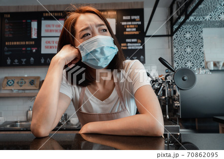 Asian woman coffee shop business owner Stressed and disappointed from The effects of the coronavirus pandemic resulting in business losses Asian woman coffee shop business owner Stressed and disappointed from The effects of the coronavirus pandemic resulting in business losses 70862095