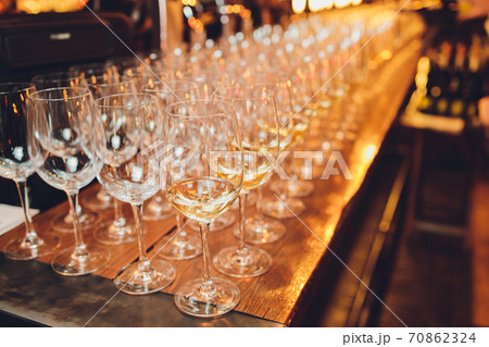 Refreshing White Wine in a Glass on a Background. Refreshing White Wine in a Glass on a Background. 70862324
