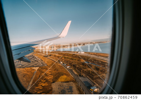 Wing of an airplane landing in Kastrup, Copenhagen airport. Wing of an airplane landing in Kastrup, Copenhagen airport. 70862459